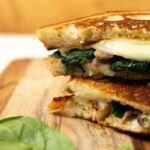 Mushroom Grilled Cheese with Greens on a cutting board
