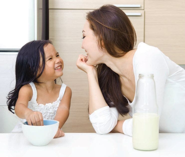 Woman and child with a jar of milk