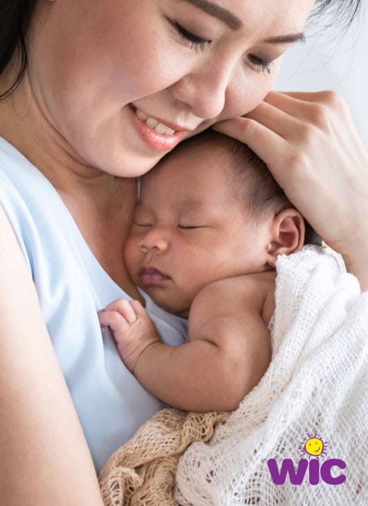 A woman holding a baby