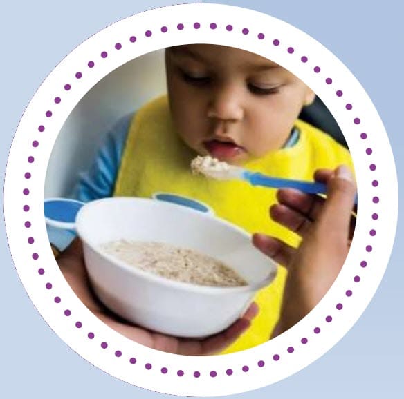 A small child eating infant cereal