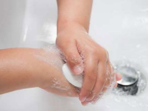 A child washing their hands