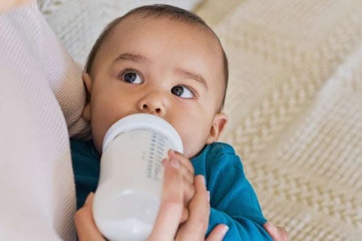 A baby drinking from a bottle