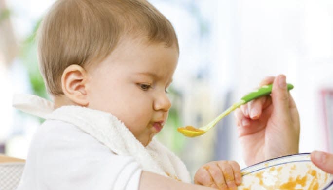 A baby eating home made baby food