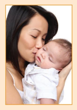 Woman kissing a baby