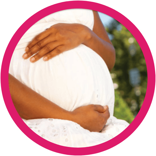 Pregnant person in a white dress holding their belly, framed in a circular photo on a bright pink background.