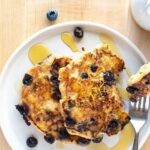 Lemon Blueberry Pancakes with syrup on a plate