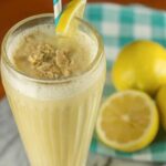 Lemon Cream Pie Smoothie in a glass with a wedge of lemon
