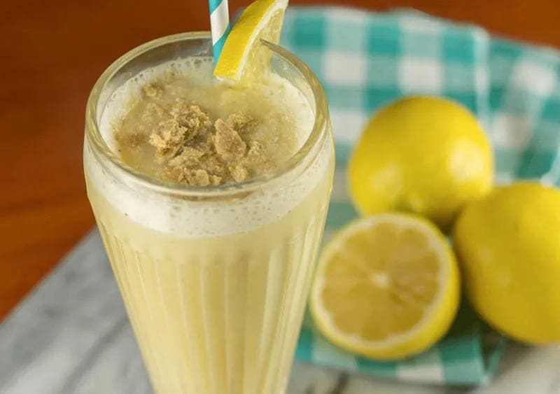 Lemon Cream Pie Smoothie in a glass with a wedge of lemon