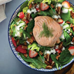 Salmon with veggies and yogurt dressing in a bowl