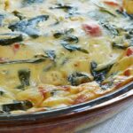 Spinach quiche in a pie pan