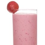 Sweet Summer Smoothie in a glass with a strawberry on the rim