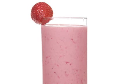 Sweet Summer Smoothie in a glass with a strawberry on the rim