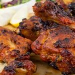 Tandoori chicken with lemon on a plate