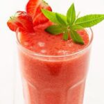 Tropical Berry Smoothie in a glass with mint and strawberries