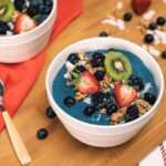 Tropical Blue Smoothie Bowl with berries and kiwi in a bowl