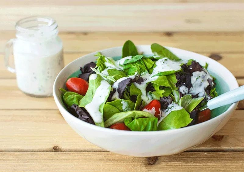 Vegan Ranch Dressing over salad in a bowl