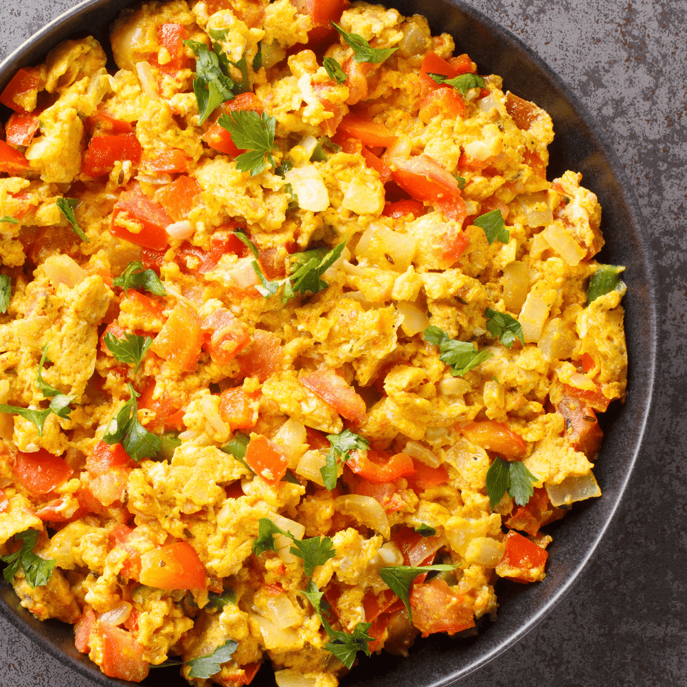 Tofu, egg and veggies scrambled together in a skillet