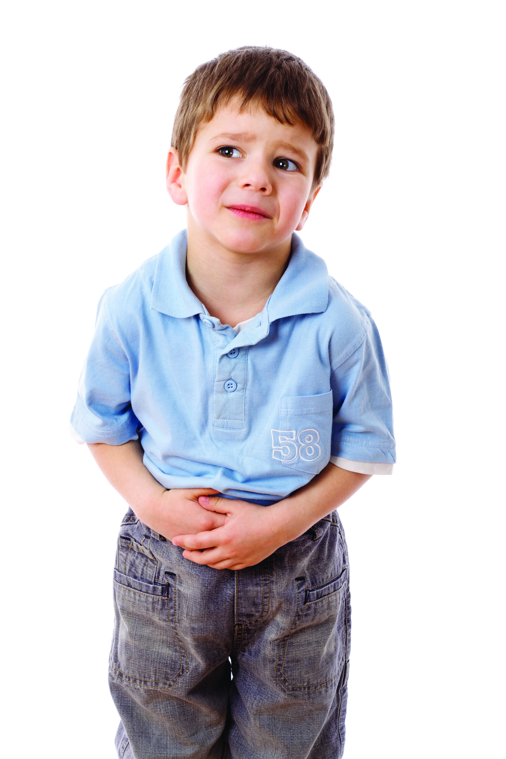 A small boy holding his stomach and looking upset